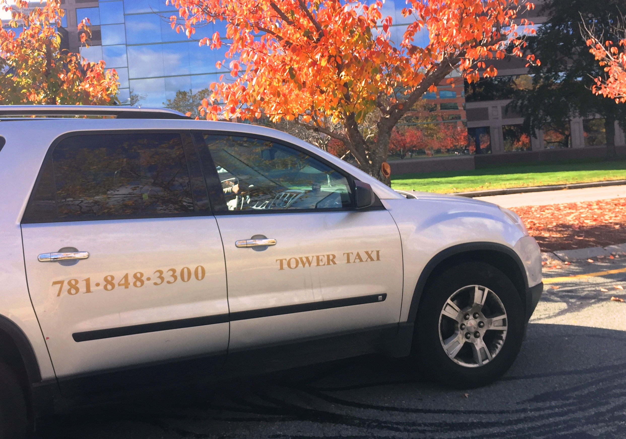 Tower Taxi silver SUV with Tower Taxi branding and 781-848-3300 number